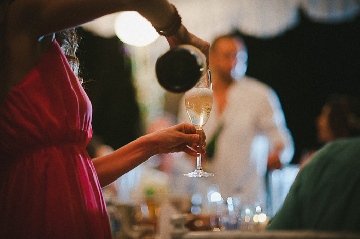 wedding guest pouring champagne