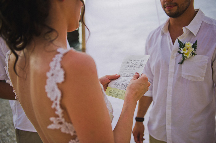 bride reading her vows on the beach