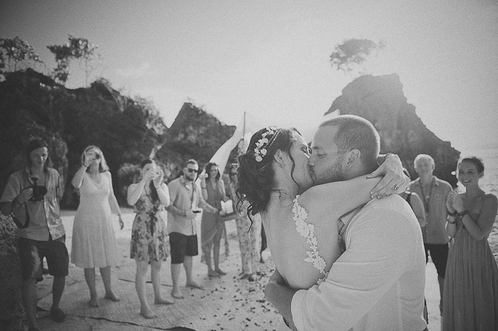 bride and groom kissing on the beach