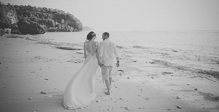 bride and groom walking on the beach in Bali