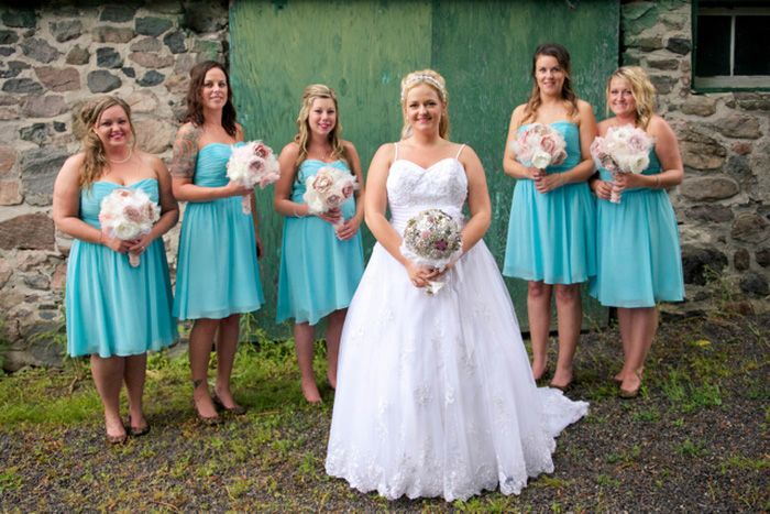 bridal party portrait in front of barn