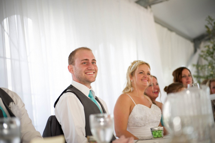 bride and groom listening to speeches