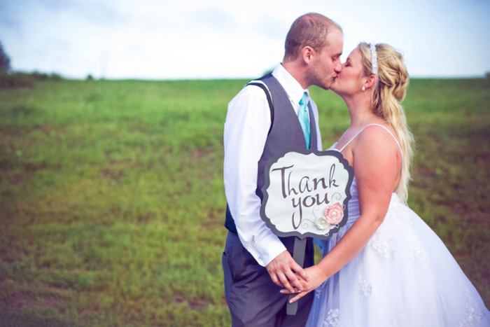 Bride and groom with thank you sign