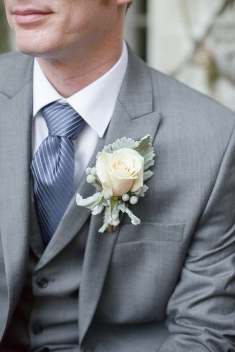 groom with white rose boutonniere