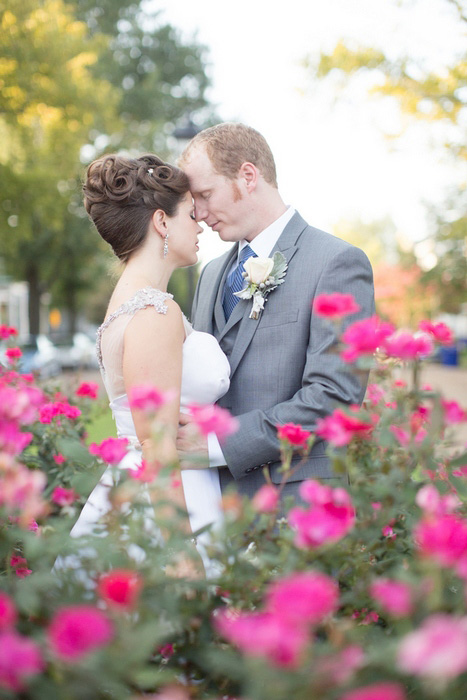 bride and groom with pink flowers