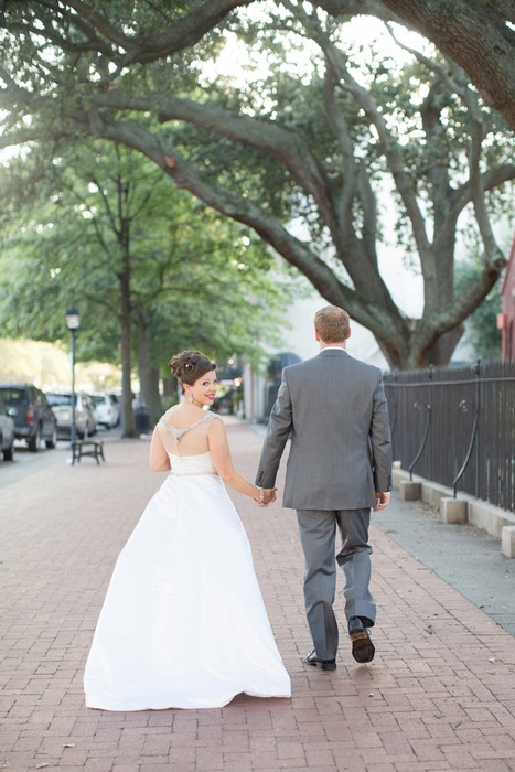 bride and groom walking down the street