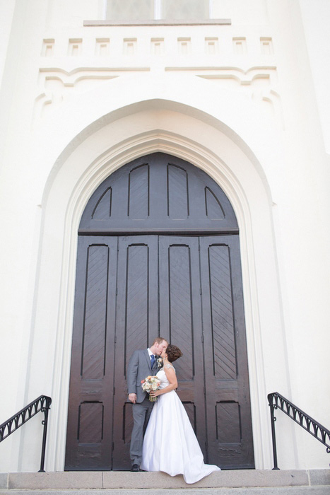 wedding portrait in front of church doors