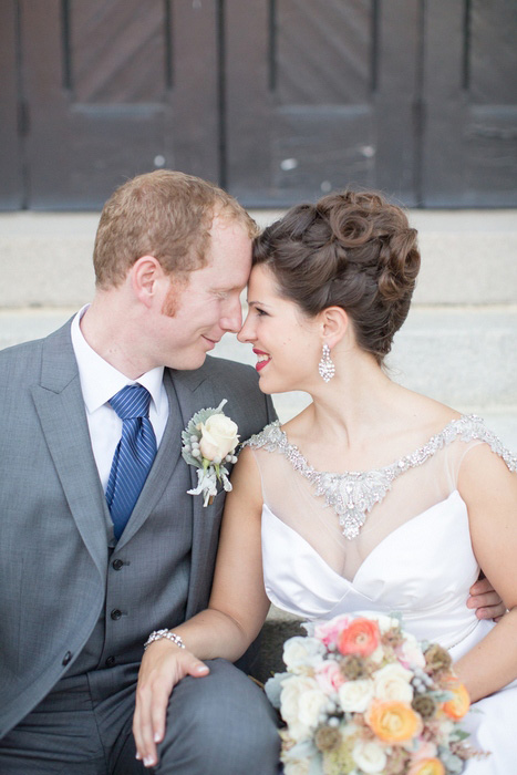 bride and groom sitting on church steps