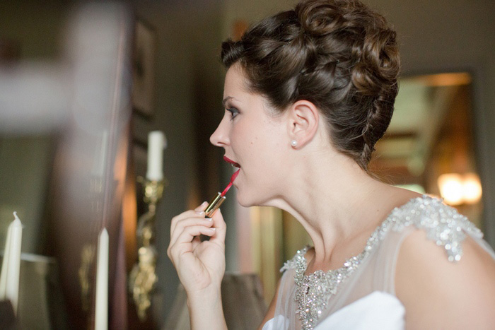 bride applying lipstick