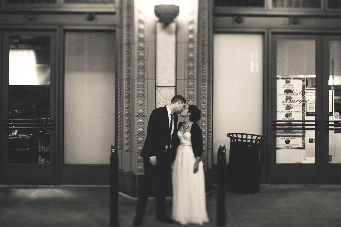 Bride and groom kissing on San Francisco street at night