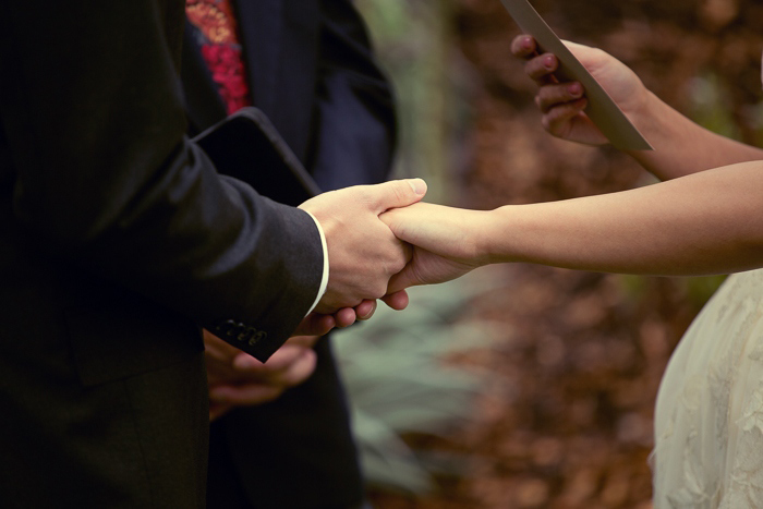 bride and groom holding hands during elopement ceremony