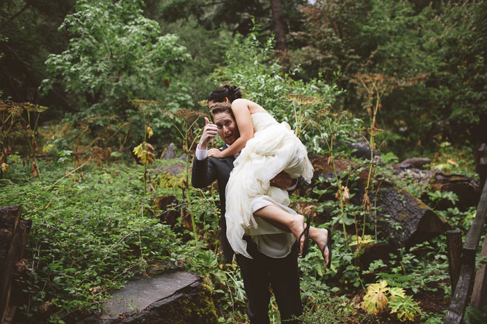 groom throwing his bride over his shoulder