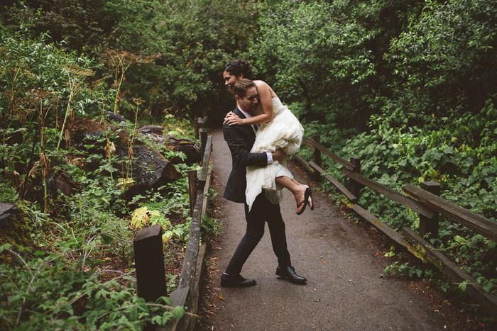 groom carrying his bride