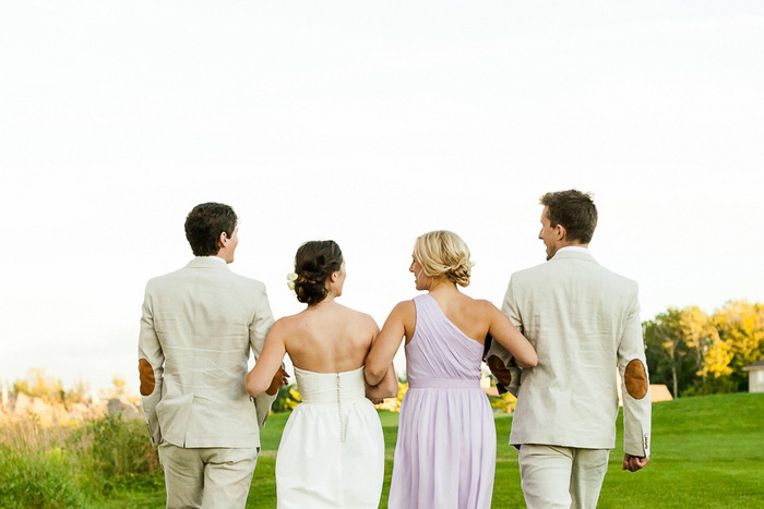 wedding party walking arm in arm