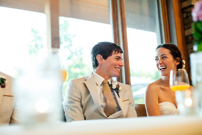 bride and groom laughing at reception