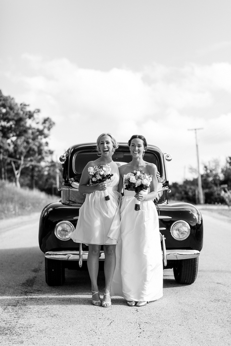 bridal party in front of vintage car