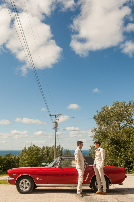 groom and best man with red convertible mustang