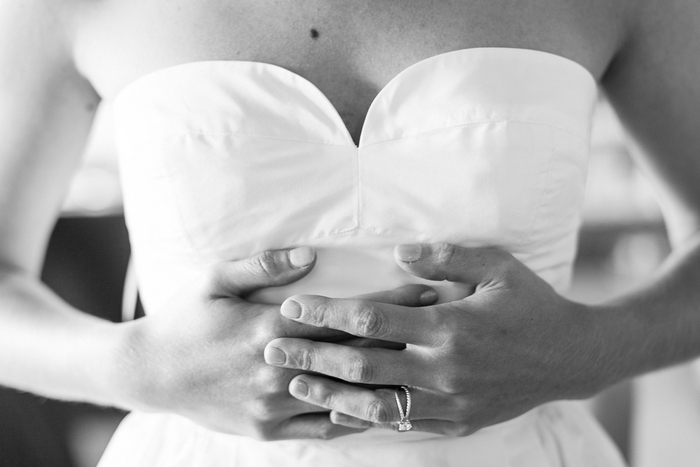 close-up of bride putting her dress on