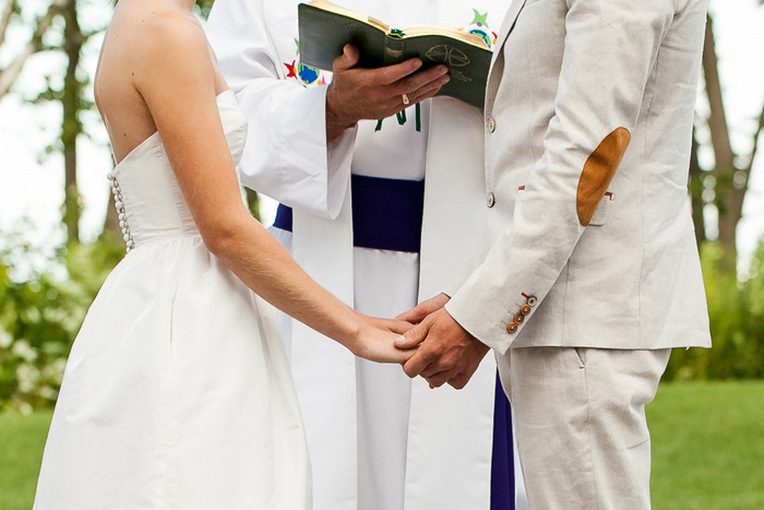 bride and groom holding hands during ceremony