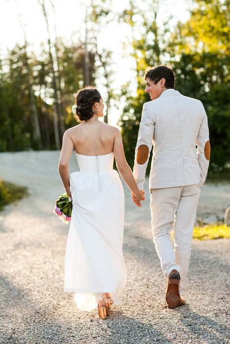 bride and groom walking at sunset