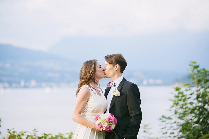 bride and groom kissing my the sea