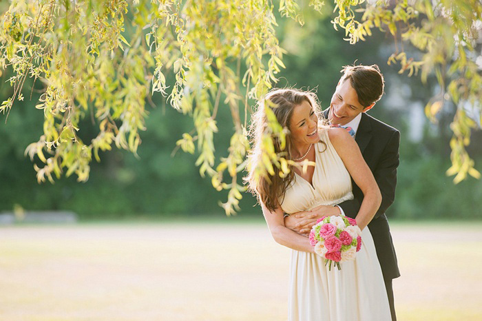 bride and groom beneath a willow tree