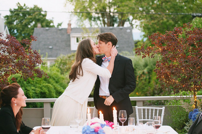 bride and groom kissing at reception