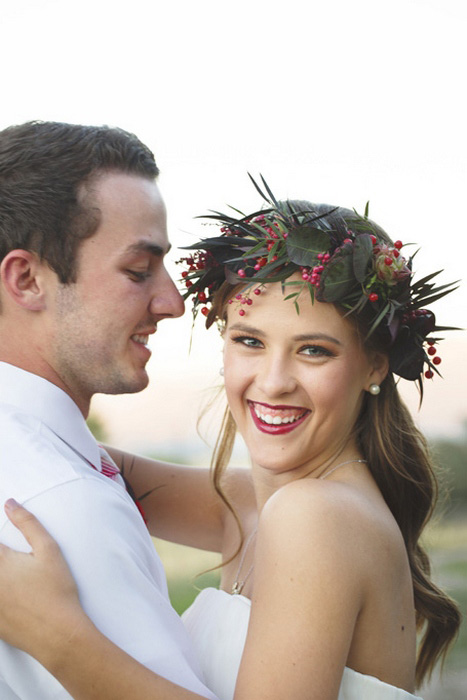 bride wearing red and green flower crown