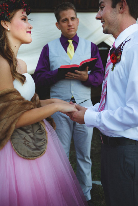 bride and groom holding hands during ceremony