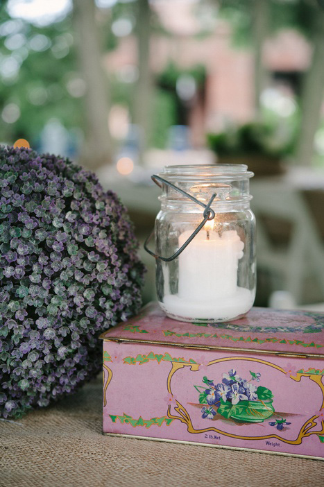 msaon jar candle holder and vintage tin on reception table