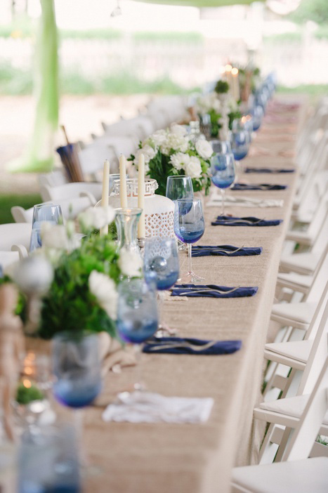 long wedding table covered in burlap