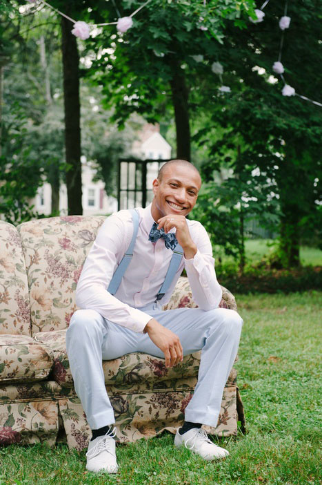 bow tied groom on vintage sofa