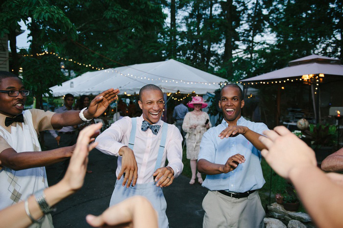 groom dancing with wedding guests