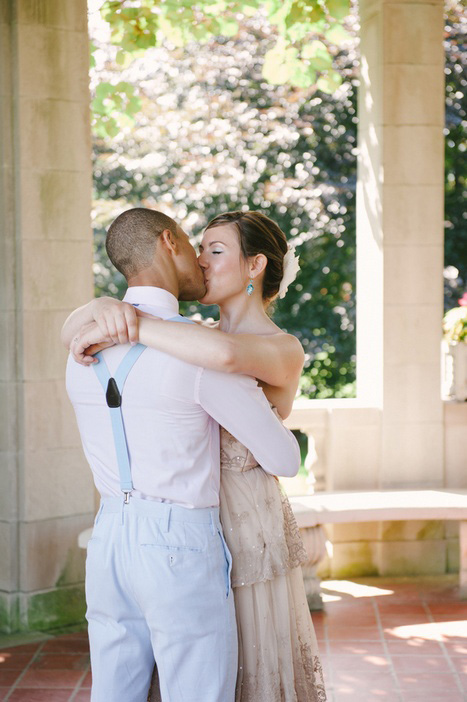 bride and groom kissing in the park