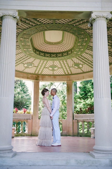 bride and groom in park gazebo