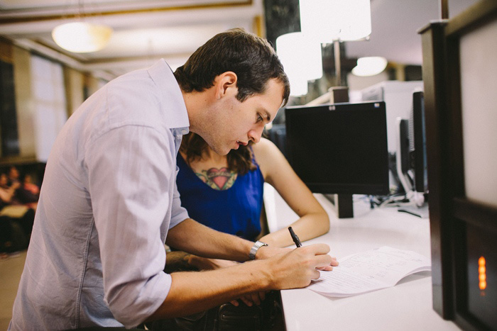 Bride and Groom signing marriage license at City Hall