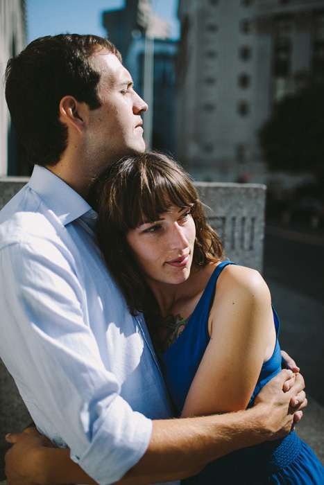 bride and groom hugging outside city hall