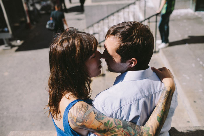 bride and groom kissing outside city hall