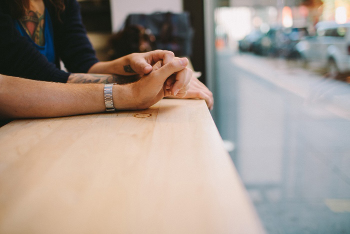 bride and groom holding hands at cafe