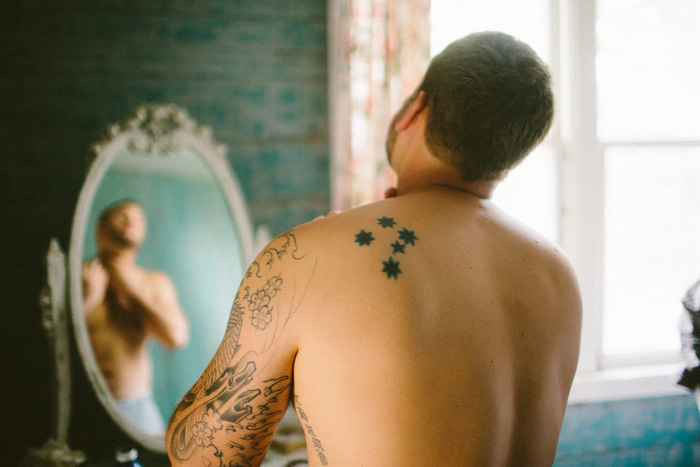 tattooed groom getting ready