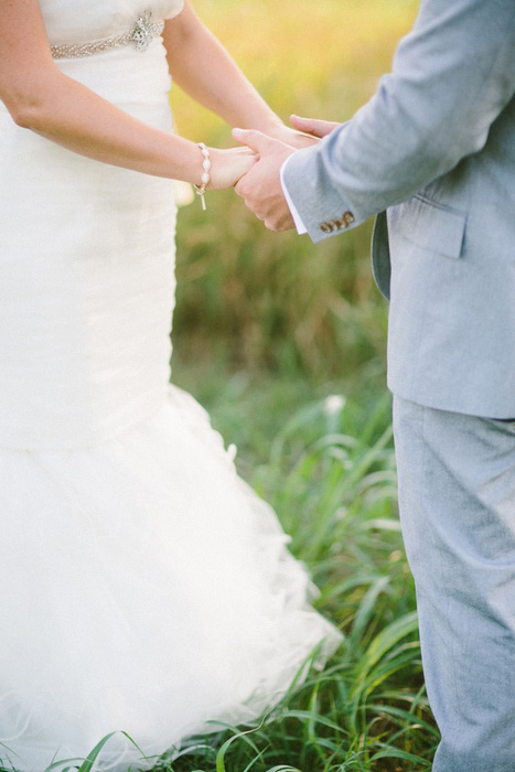 bride and groom holding hands during ceremony