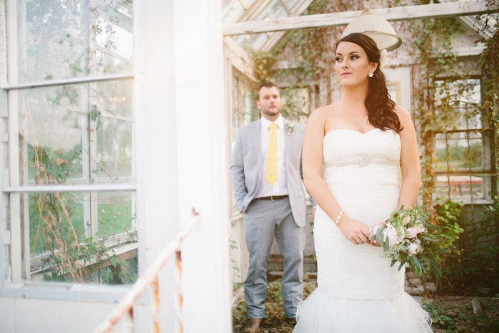 bride standing in doorway of greenhouse