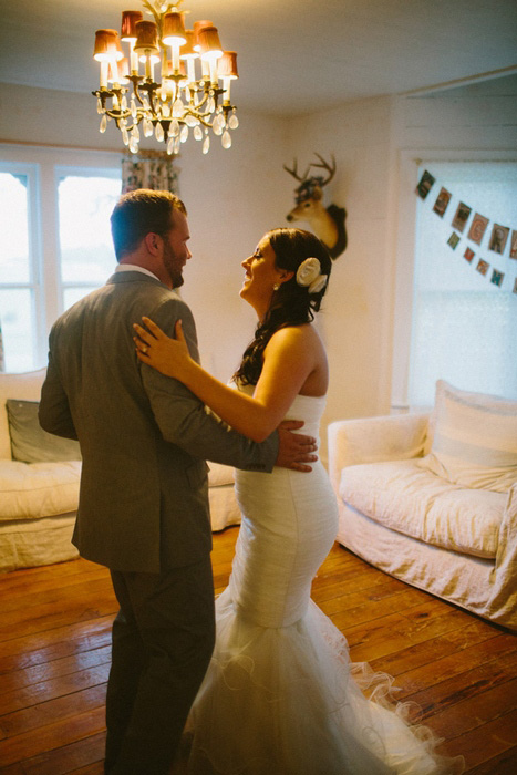 bride and groom dancing in the living room