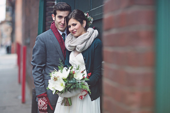 bride and groom in winter coats and scarves