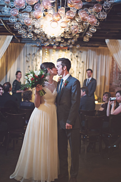 bride and groom kissing at ceremony