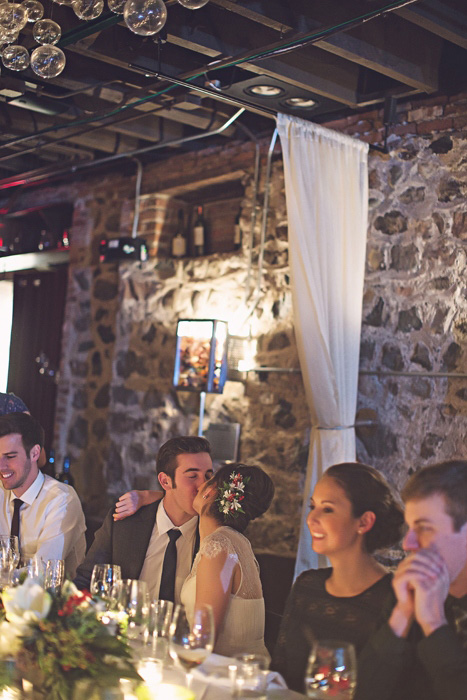 bride and groom kissing at reception