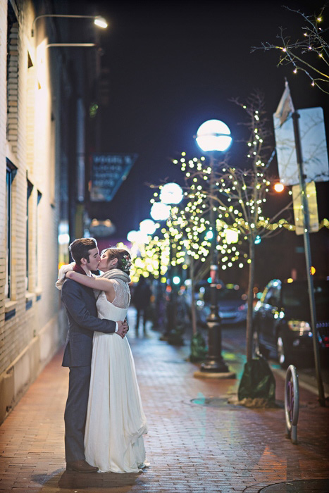 bride and groom kissing in the street