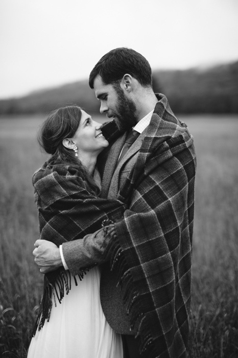 bride and groom wrapped in a blanket