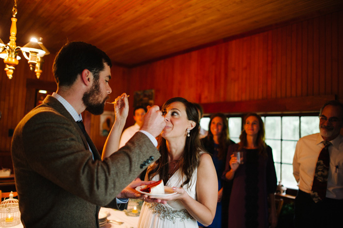 bride and groom feeding each other cake