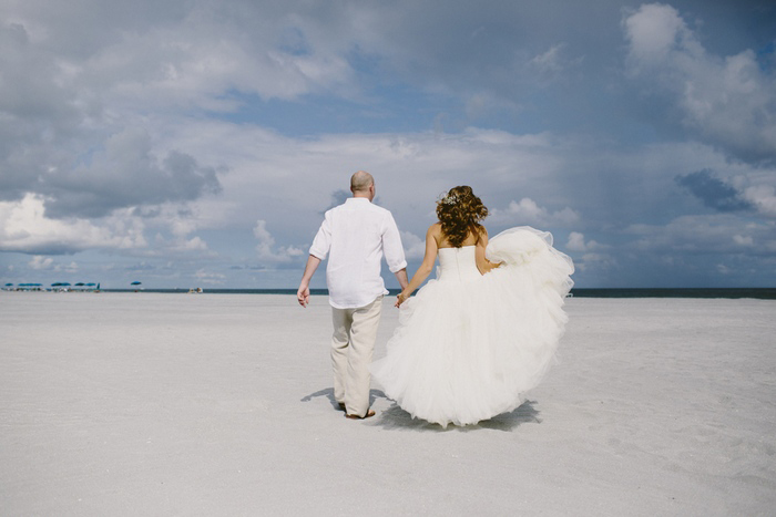 bride and groom walking on the beach